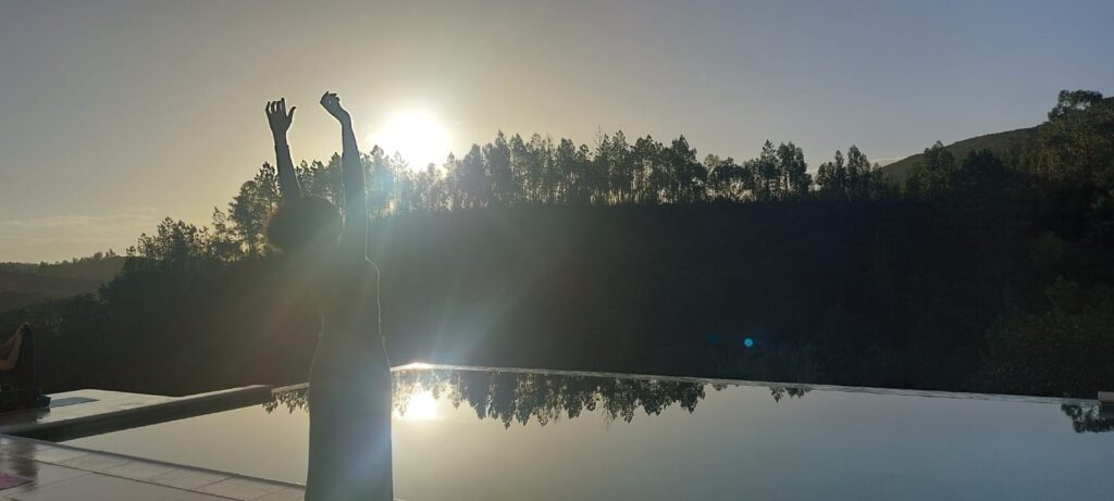 african american woman by pool at sunrise transformation retreat portugal